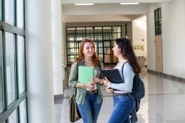 istock Happy young university students standing in corridor during break 2046383691