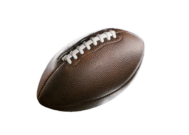 American football in a studio shot. The ball is over a black background that is lightly illuminated. High quality photo