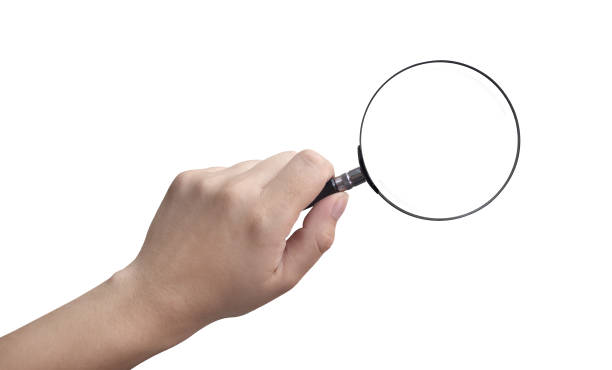 istock hand holding a magnifying glass on a white background 2046440047