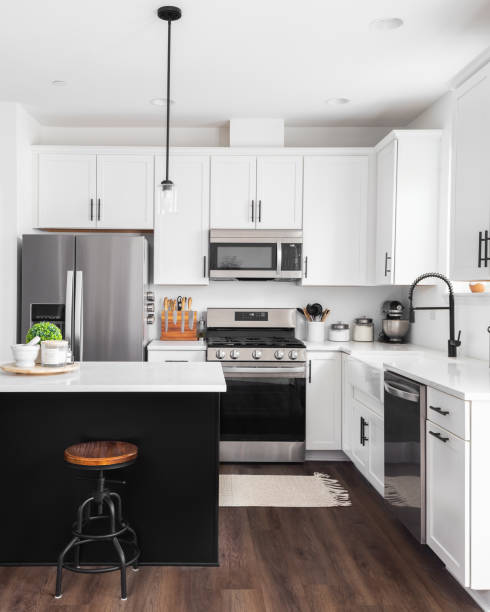 a black and white modern farmhouse kitchen with dark hardwood floors. - domestic kitchen kitchen sink contemporary counter top imagens e fotografias de stock