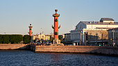 Rostral column (lighthouse) and old building on embankment Neva rive, St. Petersburg