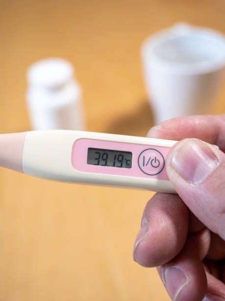 istock Checking temperature at home with digital thermometer, high body temperature, fever, high-Grade fever,self monitoring, Health and Medical concept 2046477699