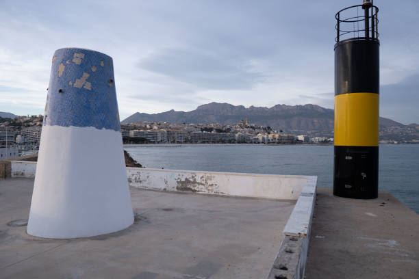 istock Buoy and a column on a dock near the water's edge 2046498573
