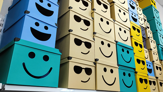Cardboard boxes with smiley face design.