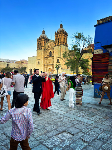 Oaxaca, Mexico: A crowd outside the Church of Santo Domingo de Guzman at dusk in downtown Oaxaca, inaugurated in 1608.