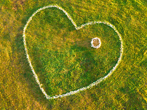 White heart balloon on a grass lawn