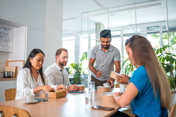 istock Mixed Race Office Colleagues Dining Together 2046624301