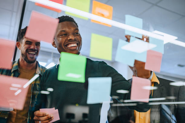 istock African american businessman writing strategy ideas on sticky notes 2046629744