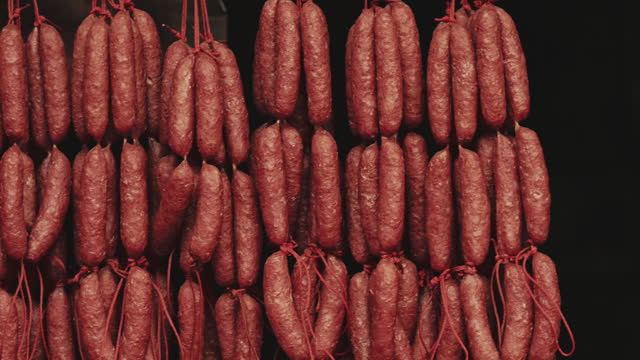Hanging sausages pork being sold at the store
