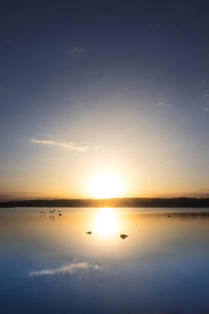 istock Sunrise over a calm lake 2046700819