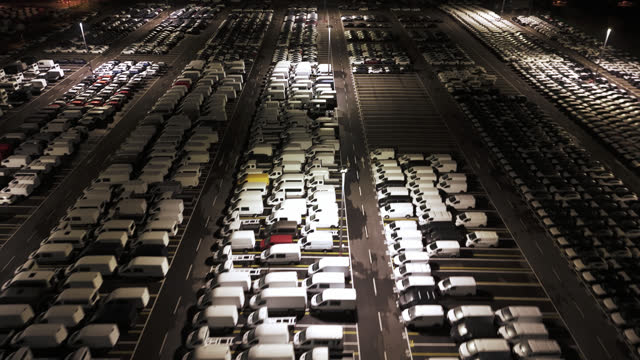 AERIAL Drone Shot Delivery Vans Parked at International Cargo Terminal at Night