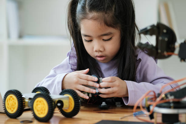 istock STEM education concept. Asian young girl learning robot design. 2046727120