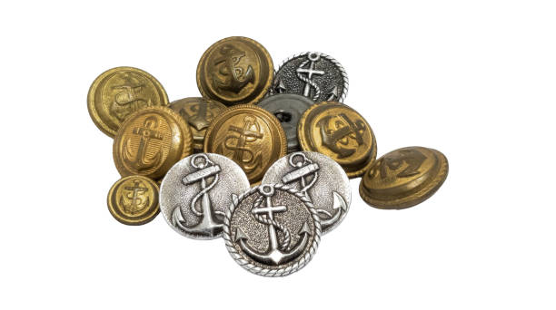Isolated photo of various colored and shaped plastic and nacre decorative cloth buttons or rivets on white background.