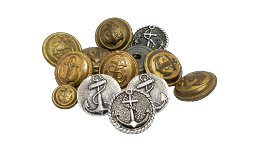 Antique sailor buttons with an anchor in relief. Isolated.