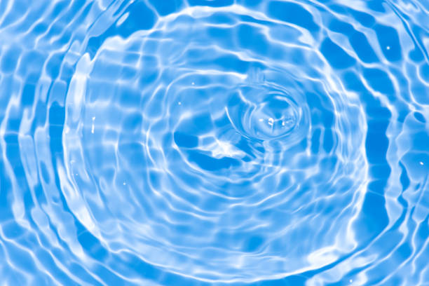 istock Waves on the beach. Blue sea wave. Blue water surface texture with ripples, splashes, and bubbles. Abstract summer banner background Water waves in sunlight with copy space cosmetic moisturizer. 2046751417