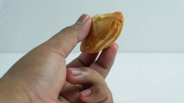 istock Klemben bread held in hand on white background 2046755256