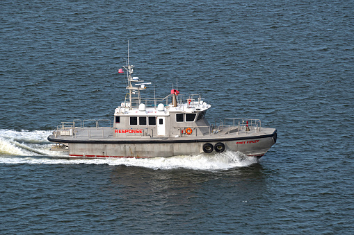 Charleston, SC, USA - February 28, 2024: Fort Riley, a 20-meter U.S. Coast Guard-certified emergency response craft owned by Southeast Ocean Response Services, sails into Charleston Harbor.