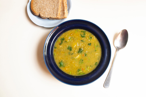 Delicious  soup with green lentils ready to eat for lunch at home .