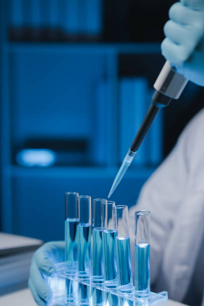 Many test tubes were analyzed by experts, A researcher is carefully studying the liquid contained in a test tube because it is an important area of research. stock photo