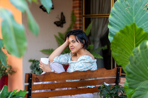 Portrait of a woman relaxing at home in her garden