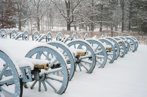 Rows of cannons covered with snow at Artillery Park in Valley Forge National Historic Park, King of Prussia, Pennsylvania, USA