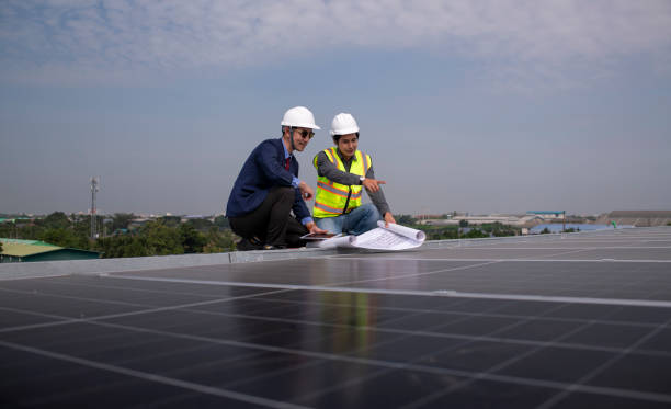 istock Engineers walking on roof inspect and check solar cell panel by hold equipment box and radio communication ,solar cell is smart grid ecology energy sunlight alternative power factory concept. 2046873857