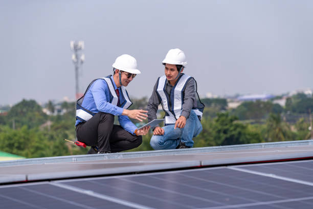 istock Engineers walking on roof inspect and check solar cell panel by hold equipment box and radio communication ,solar cell is smart grid ecology energy sunlight alternative power factory concept. 2046874011