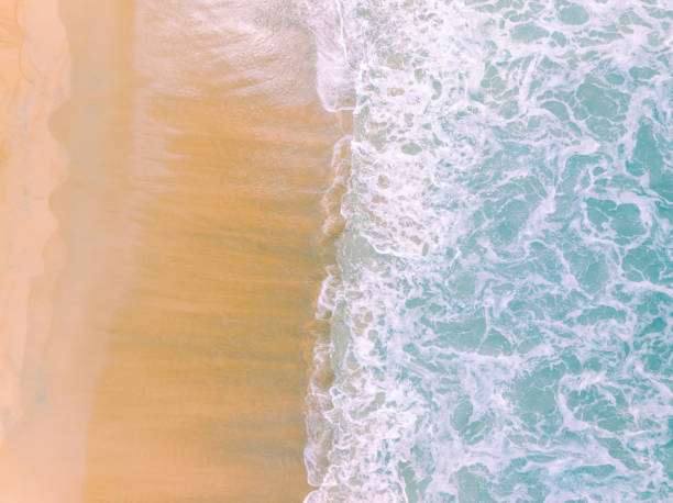 istock Top view beach with waves crashing on sandy shore,Beautiful waves sea surface in summer seascape background,Amazing beach colorful water background 2046918653