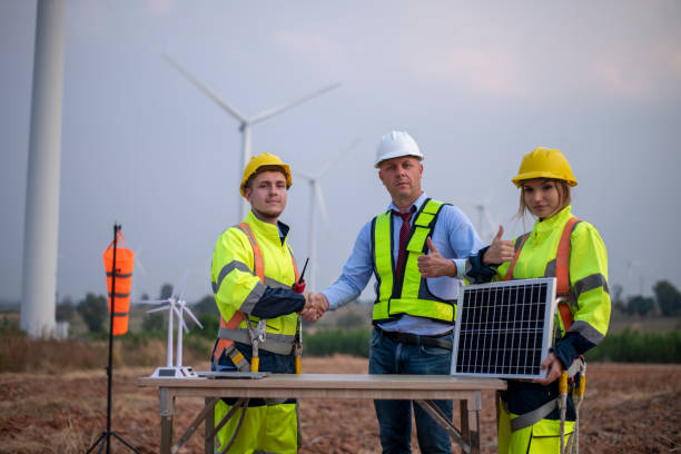 istock Engineer surveyor and manager wearing uniform walking holding box inspection and tablet work in wind turbine farms rotation to electricity, alternative renewable energy for clean power energy concept. 2046929175