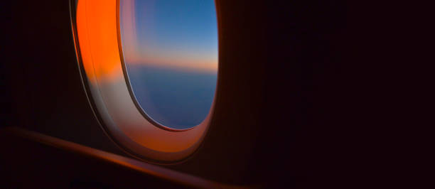 istock Looking out an Airplane window at sunrise or sunset 2046980142