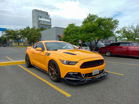 Buenos Aires, Argentina - Feb 25, 2024: Modern yellow sport Saleen CID 302 Mustang based coupe at a classic car show in a parking lot