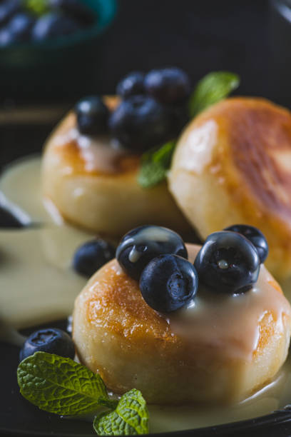 istock Cheesecakes served with berries and condensed milk 2047077017