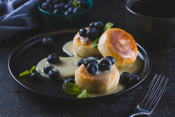 istock Cheesecakes served with berries and condensed milk 2047077031
