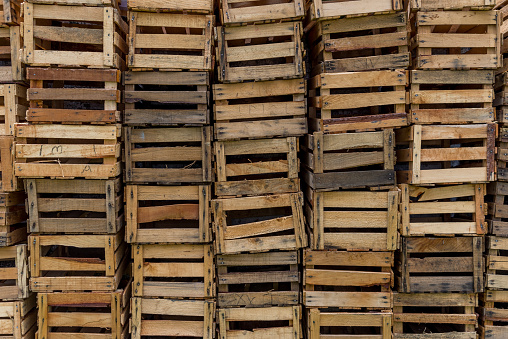 Empty wooden pallets packed in warehouse