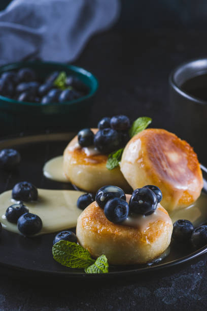 istock Cheesecakes served with berries and condensed milk 2047077549