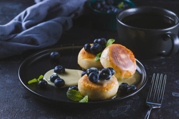istock Cheesecakes served with berries and condensed milk 2047077551