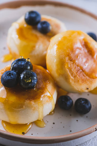 istock Cheesecakes served with berries and honey 2047077759