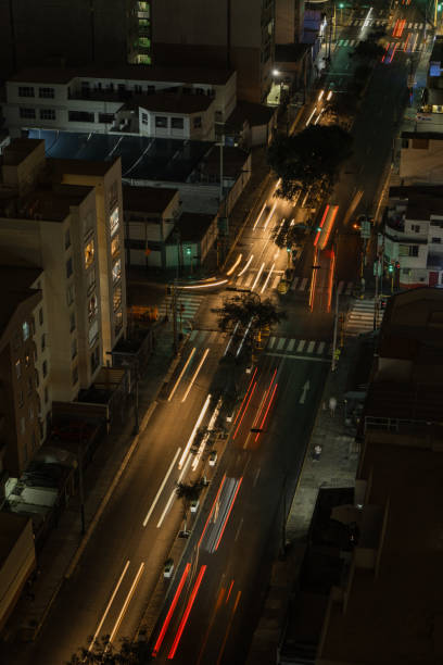 istock Aerial view Traffic speeds through an intersection at night on a main road. long exposure 2047081210