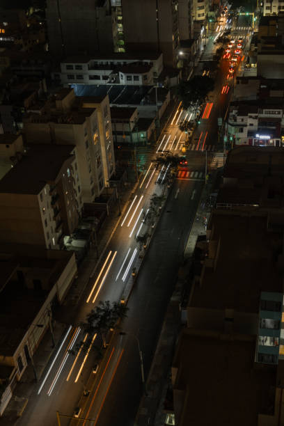 istock Aerial view Traffic speeds through an intersection at night on a main road. long exposure 2047081211