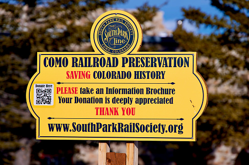 Como, Colorado, USA - February 12, 2024: Close-up of a sign near the historic Como Roundhouse soliciting donations to the South Park Rail Society.