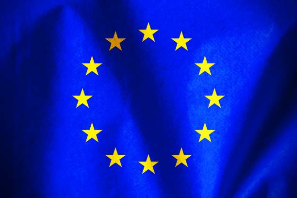 Small paper flag of European Union against flags of EU member-states