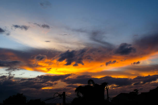 Aerial Photography. Sunset view Golden sky behind the clouds. Golden light shining in the late afternoon, aerial view. Shot from a drone flying 200 meters high