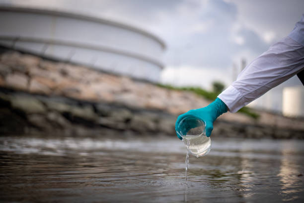 istock Scientist and engineer wearing protective uniform and glove under working water analysis and water quality by get waste water to check case in laboratory is environment pollution problem concept 2047153308