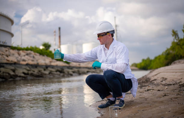 istock Scientist and engineer wearing protective uniform and glove under working water analysis and water quality by get waste water to check case in laboratory is environment pollution problem concept 2047153310