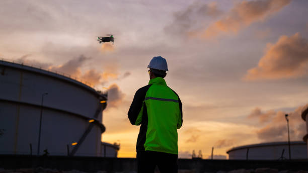 istock Engineer surveyor team under used drone camera for operator inspecting and survey construction site with gas oil refinery background 2047154354