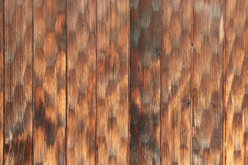 Japanese historical cedar plank wall texture with decorative carvings in hexagonal patterns.