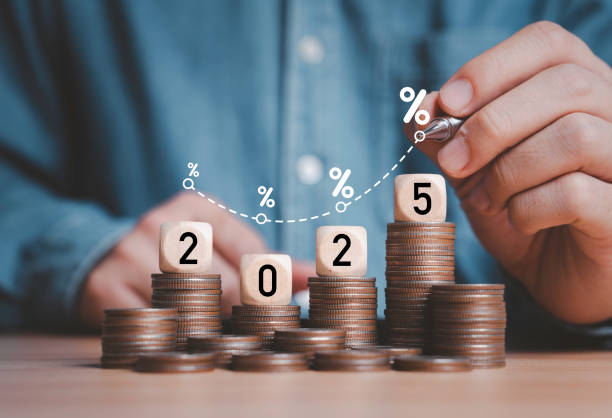 istock Businessman drawing increasing trend graph with percentage on 2025 year and coins stacking for financial budget planing in new year concept. 2047169912