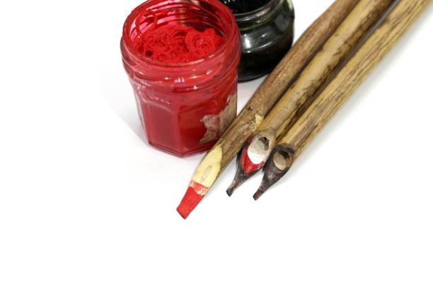 Arabic calligraphy pens and inkwell, calligrapher’s pen made of reed, Arabic language culture, isolated on a white background