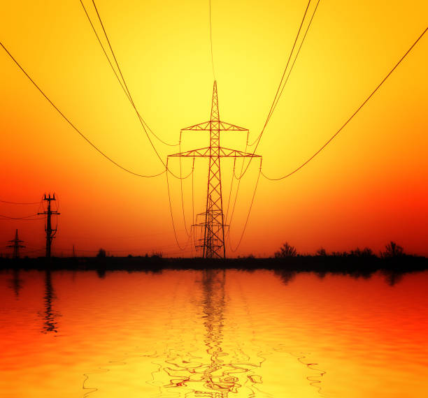 Industrial high voltage electricity tower at sunset