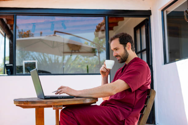 istock Doctor is teleworking from home on his laptop 2047215149